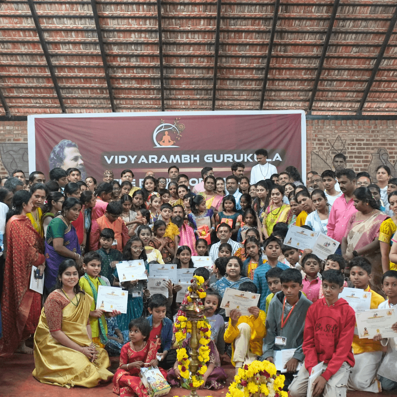 A full hall of children at a Vidyarambh Gurukula gathering