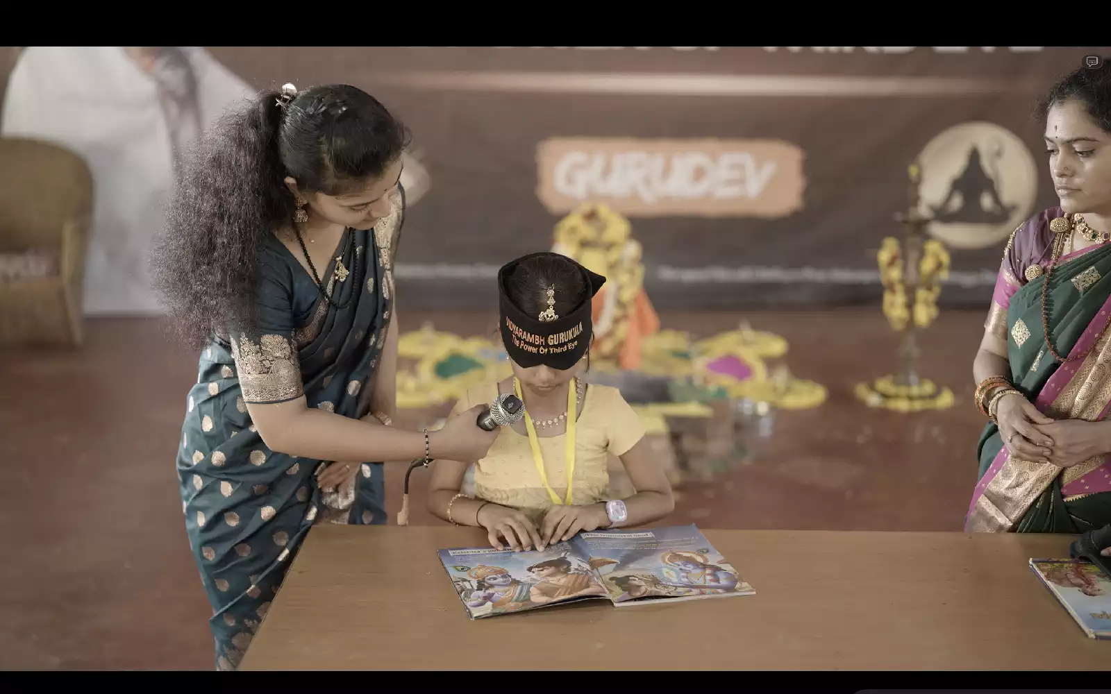The demonstration — a blindfolded child reads