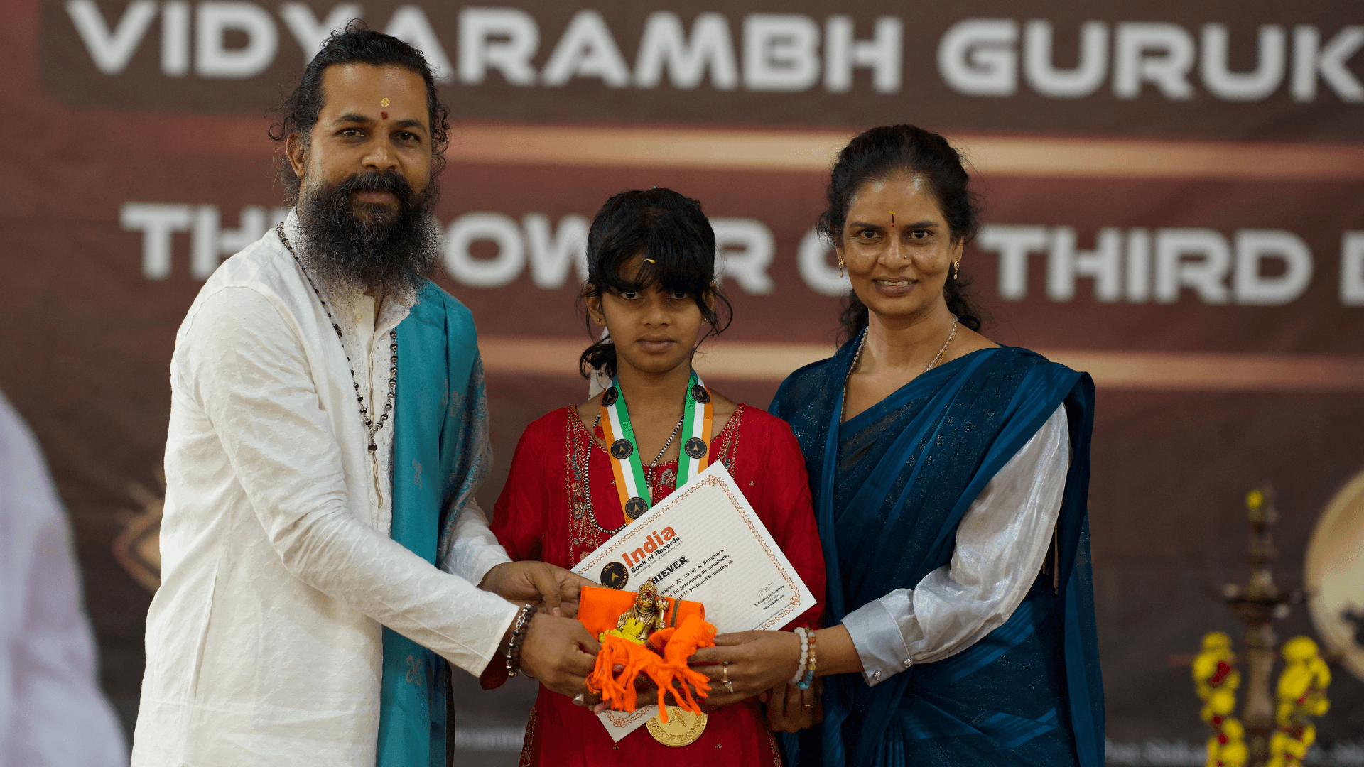 A child receiving their record certificate